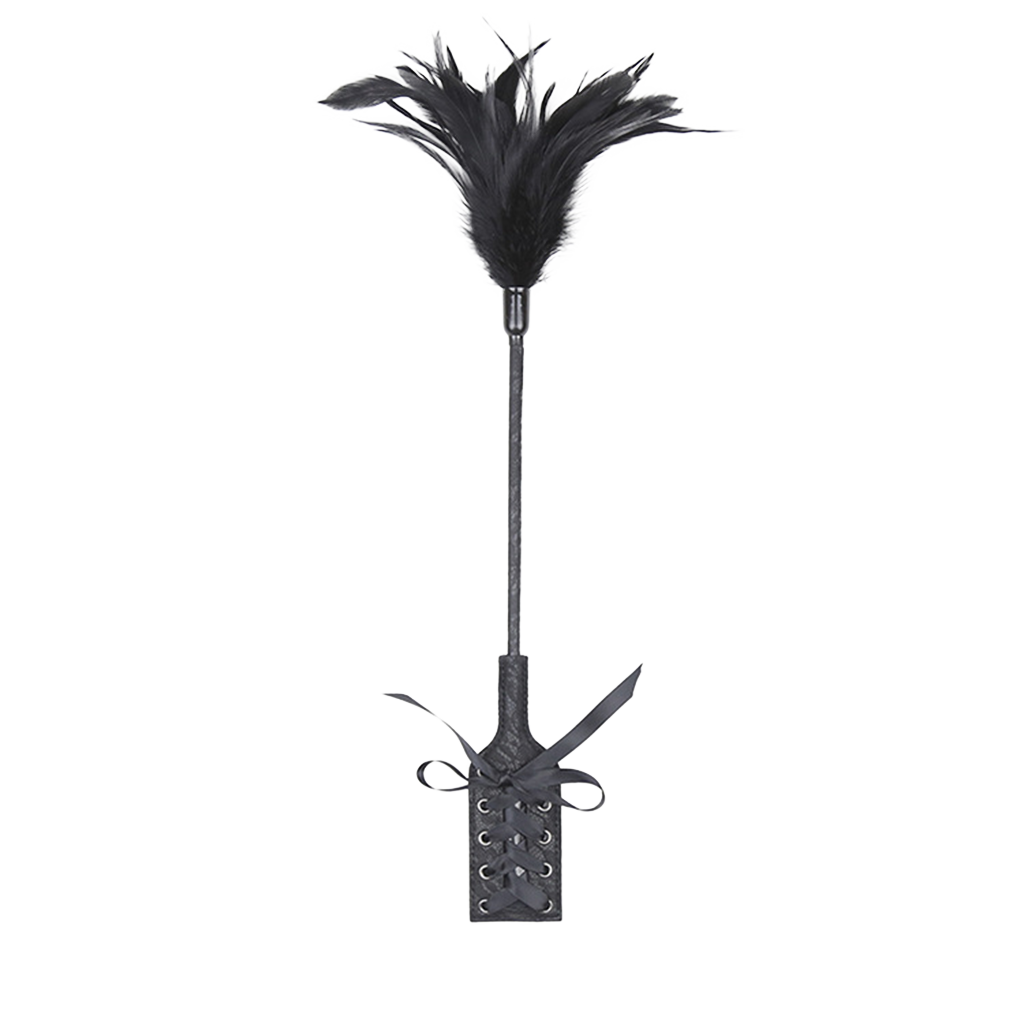 Black feather whip with an attached paddle with vintage design on a white background.